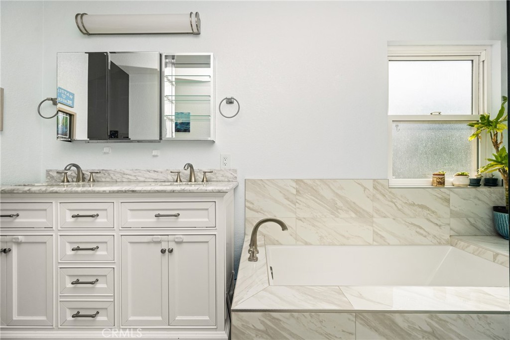 7958 East Bauer Road Anaheim, CA 92808 - Photo 27 of 45 a bathroom with a granite countertop sink and a mirror