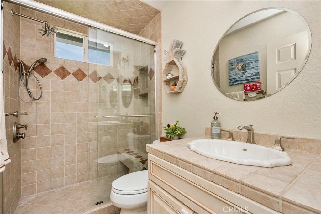 7958 East Bauer Road Anaheim, CA 92808 - Photo 31 of 45 a bathroom with a granite countertop sink and a mirror