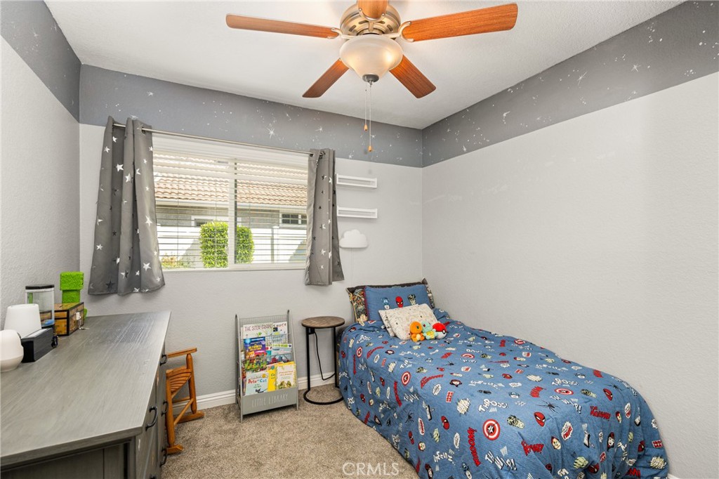 7958 East Bauer Road Anaheim, CA 92808 - Photo 34 of 45 a bedroom with a bed and a chandelier