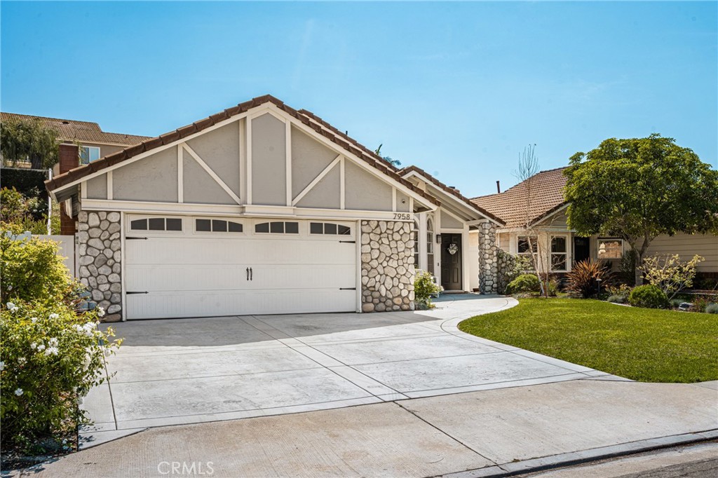 7958 East Bauer Road Anaheim, CA 92808 - Photo 5 of 45 a view of a white house with a big yard and large trees
