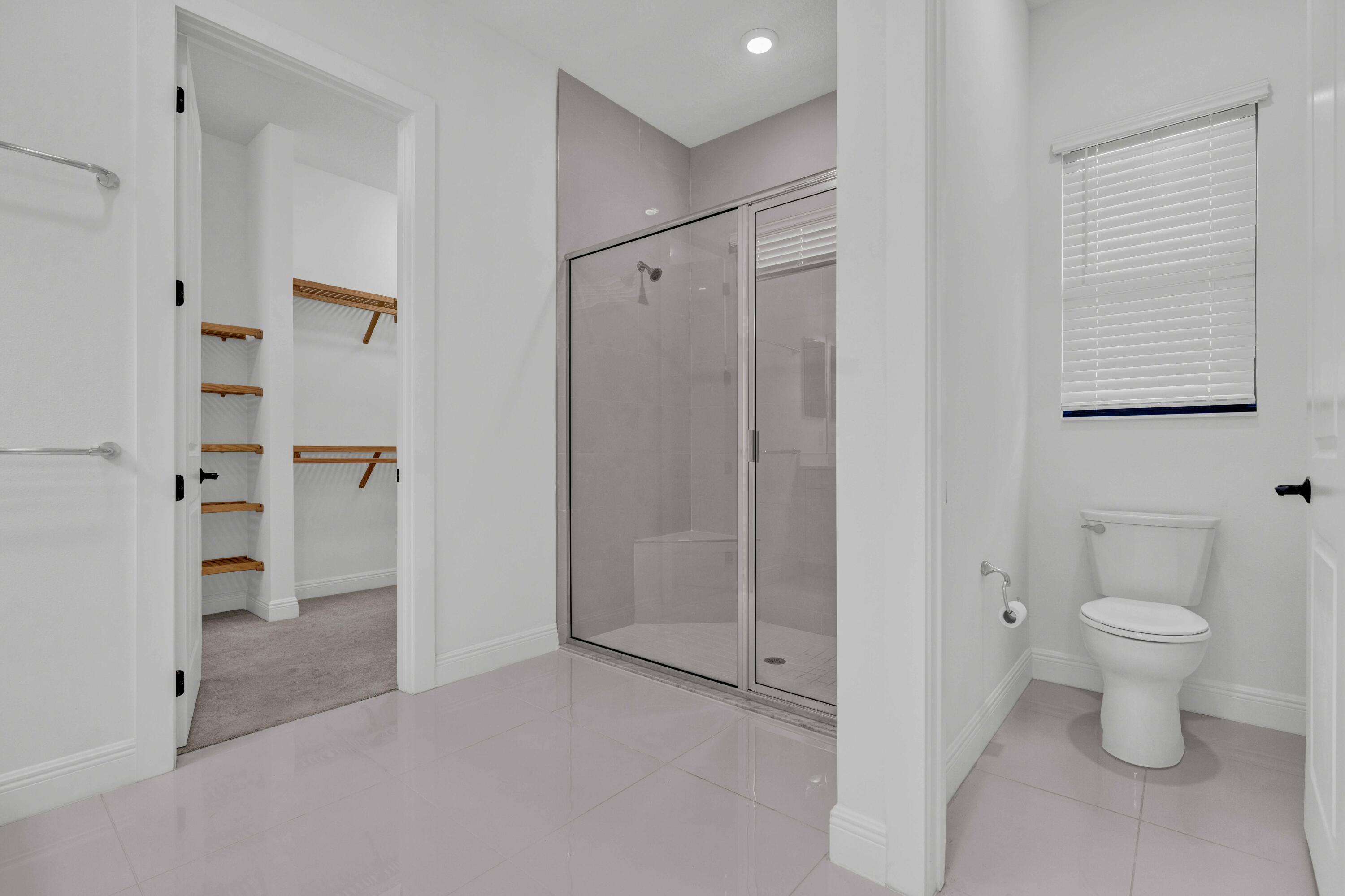 5501 Santa Rosa Lane Westlake, FL 33470 - Photo 20 of 31 a bathroom with a toilet and a shower