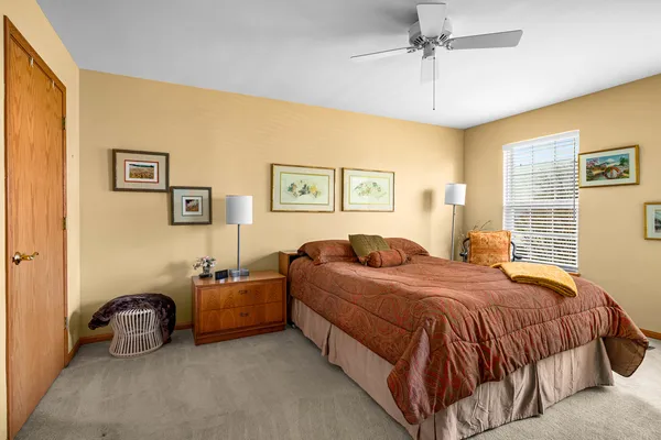 a bedroom with a bed and ceiling fan