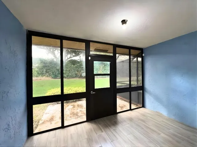 wooden floor in an empty room with windows