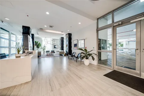 a view of a room with lots of furniture and wooden floor