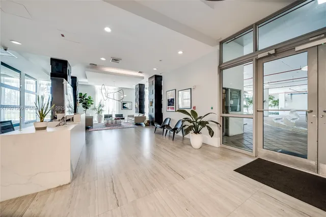 a view of a room with lots of furniture and wooden floor