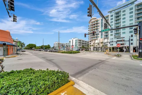 a city street with tall buildings in the background