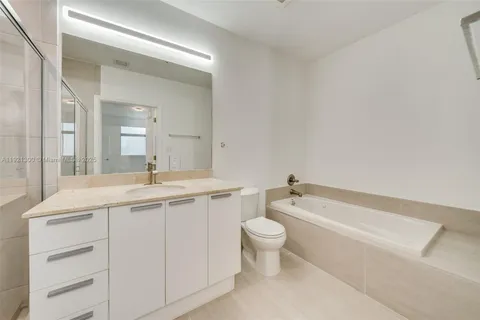 a bathroom with a toilet a sink and bathtub