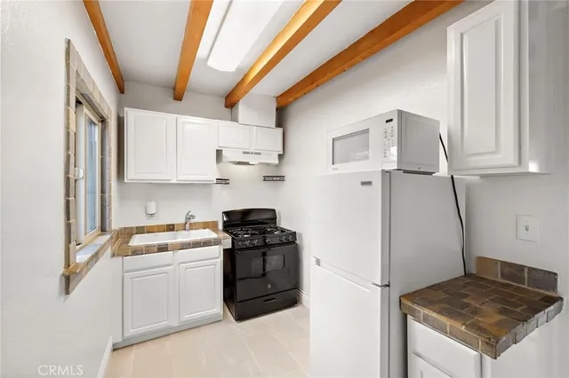 a kitchen with a sink stove and refrigerator