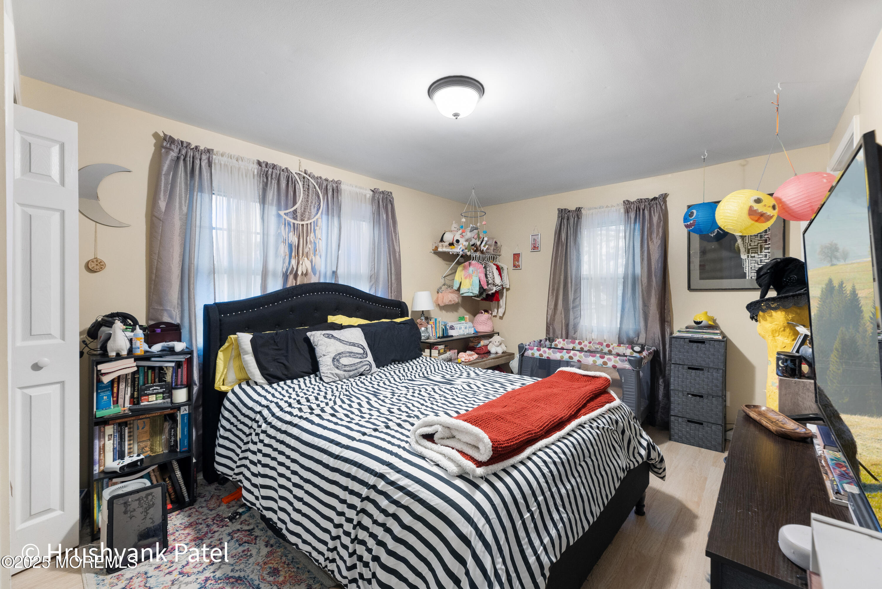 Mantoloking Road Brick, NJ 08723 - Photo 17 of 24 a bedroom with bed and wooden floor
