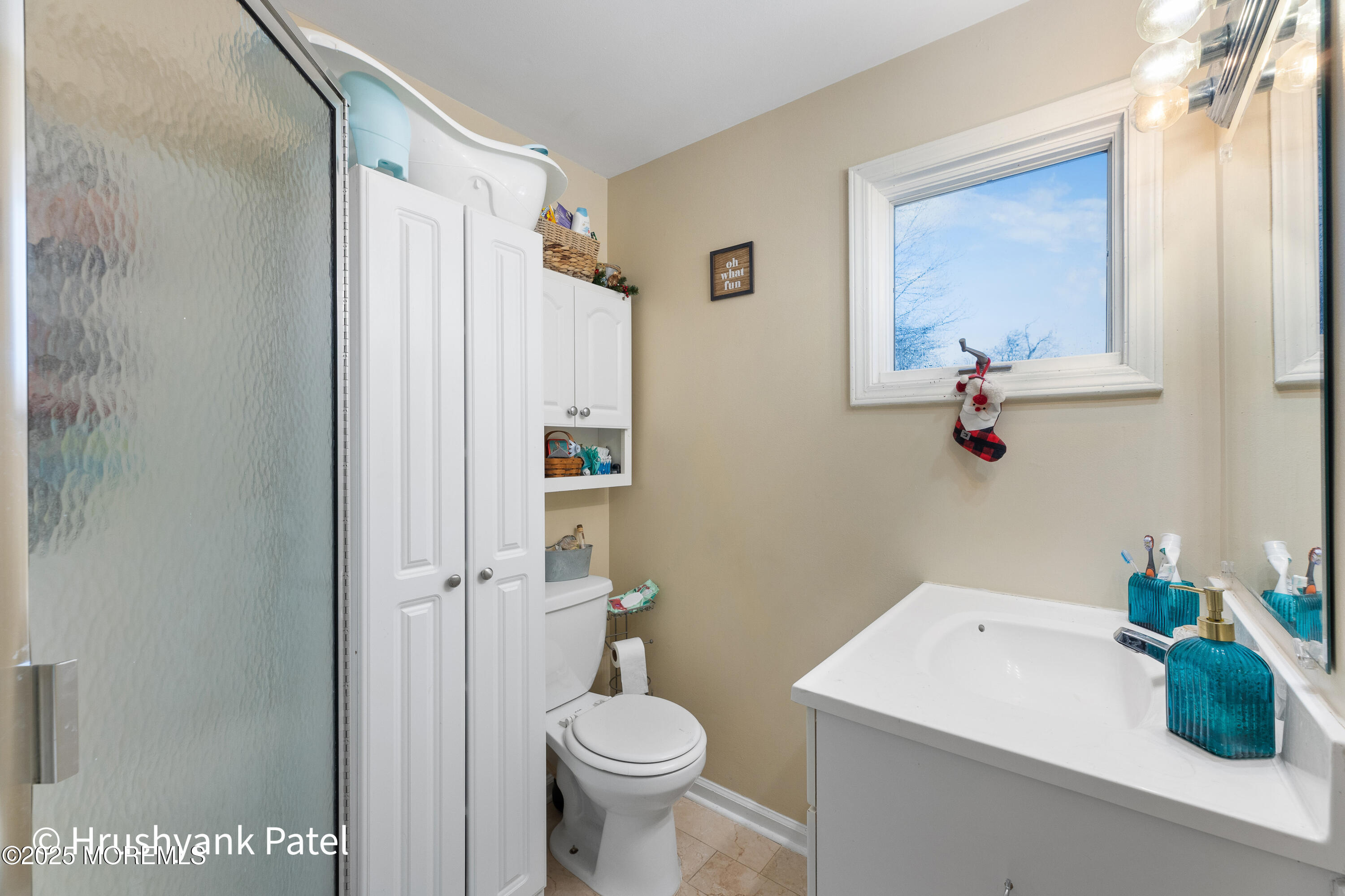 Mantoloking Road Brick, NJ 08723 - Photo 18 of 24 a bathroom with a sink a toilet and a mirror