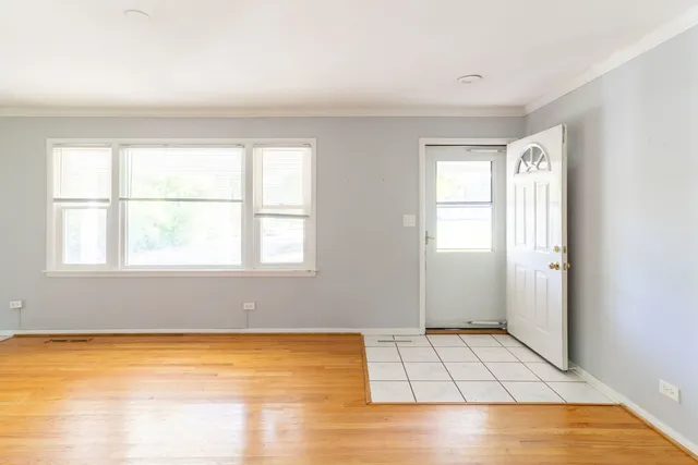 an empty room with a fireplace and windows