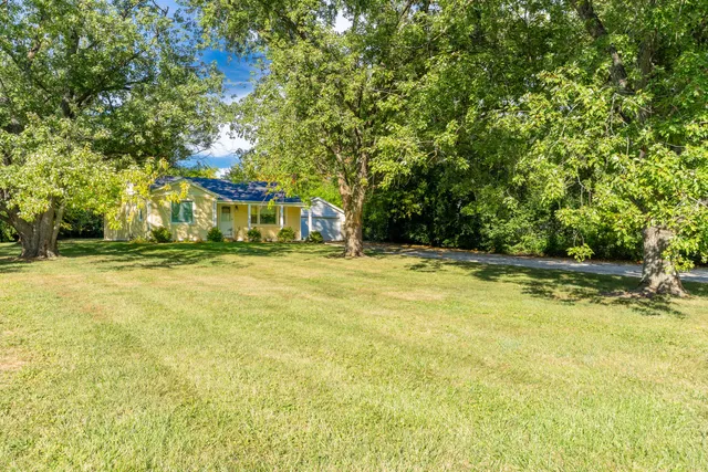 a house view with swimming pool in front of the house