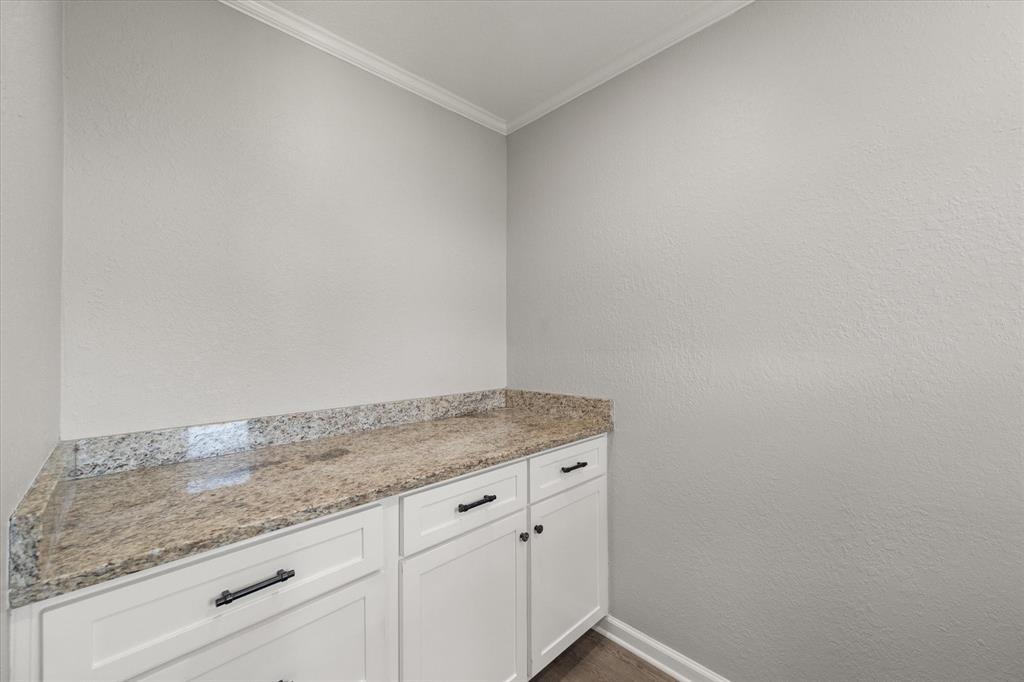 1009 North Spikes Road Corsicana, TX 75110 - Photo 16 of 31 a utility room with granite countertop cabinets and sink