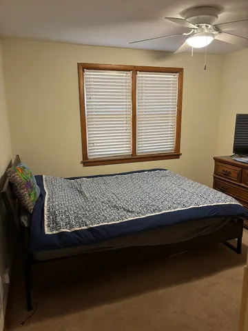 a bed sitting in a bedroom next to a window