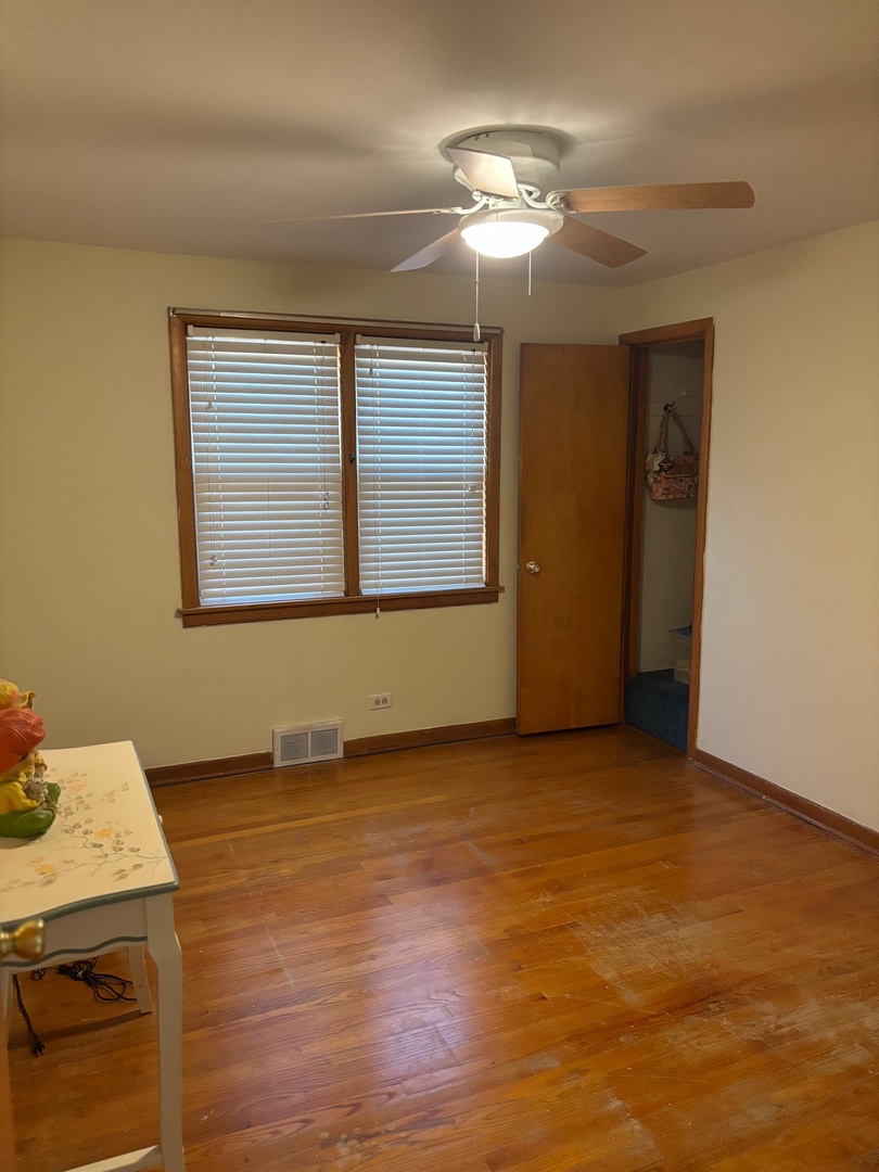 5137 South Rutherford Avenue Chicago, IL 60638 - Photo 12 of 23 a view of an empty room with window and wooden floor