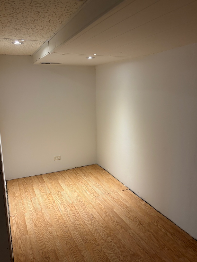 5137 South Rutherford Avenue Chicago, IL 60638 - Photo 16 of 23 an empty room with wooden floor and windows