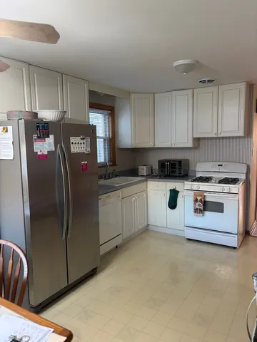 a kitchen with stainless steel appliances granite countertop a refrigerator sink and cabinets