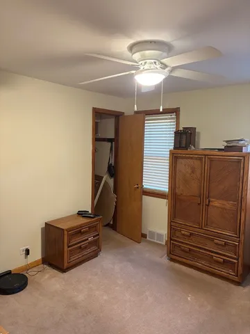 a room with furniture and a ceiling fan