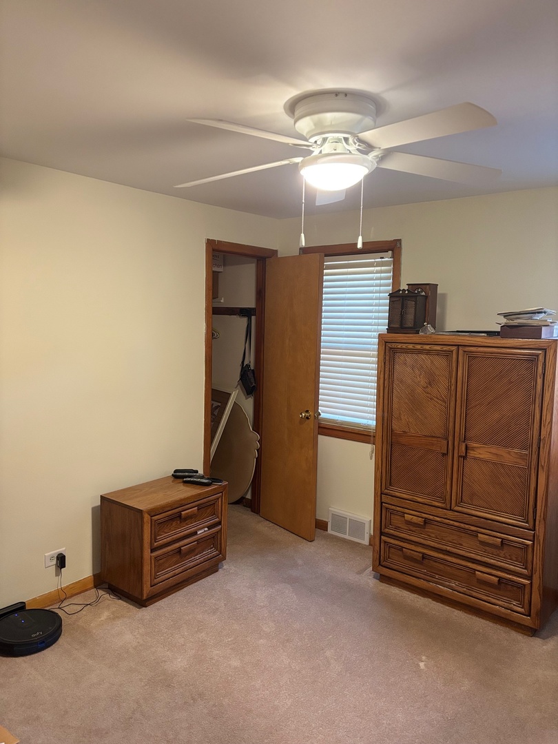 5137 South Rutherford Avenue Chicago, IL 60638 - Photo 10 of 23 a room with furniture and a ceiling fan
