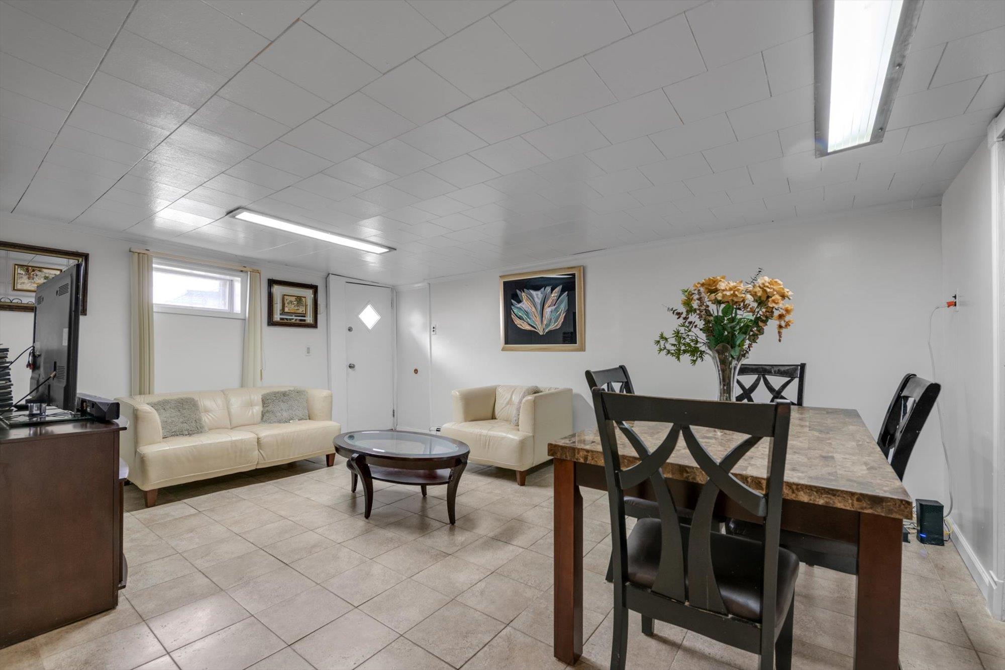 63-03 74th Street Queens, NY 11379 - Photo 12 of 15 Living room with light tile patterned floors