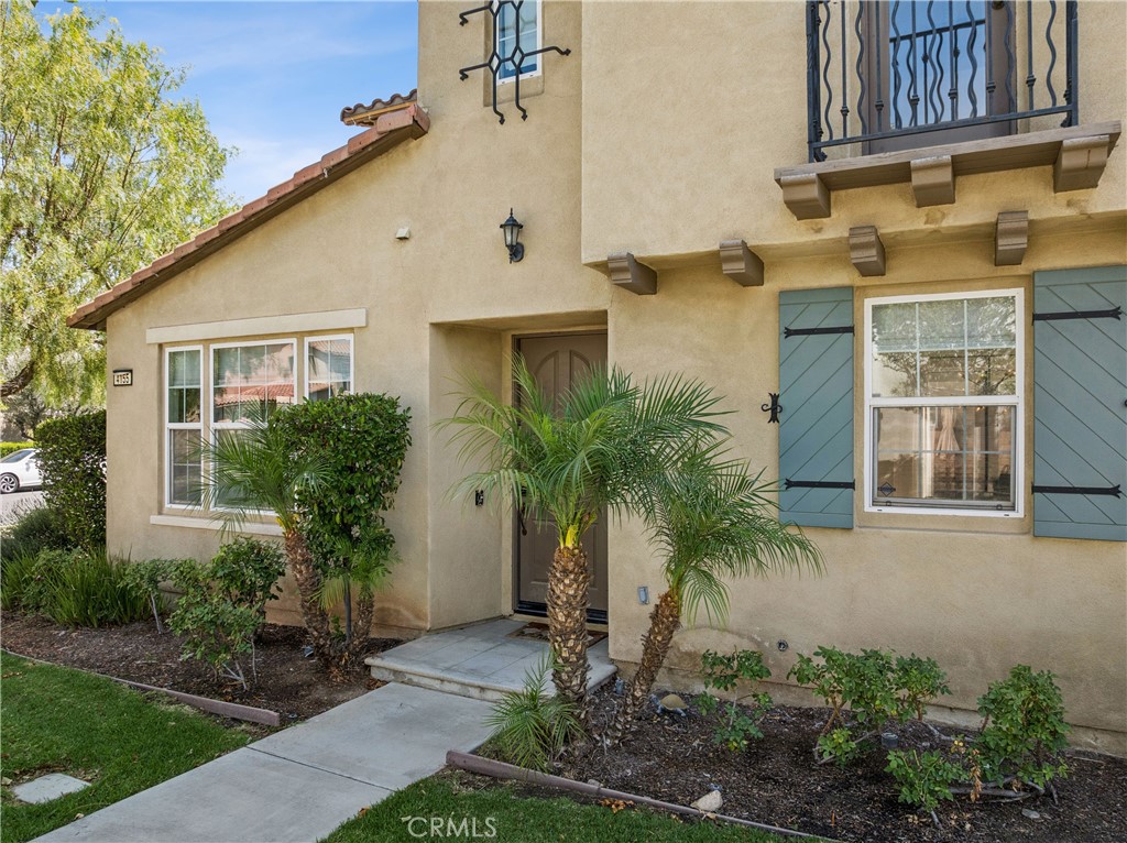 4155 Windspring Street Corona, CA 92883 - Photo 5 of 38 a front view of a house with a yard
