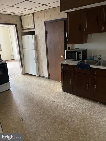 a kitchen with a refrigerator and cabinets