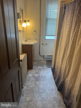 a bathroom with sink a toilet and shower