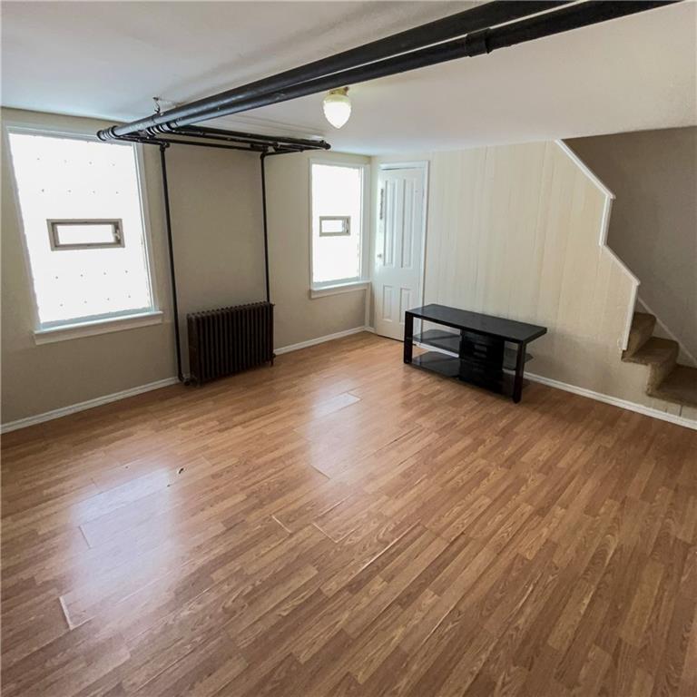 1360 Center Street McKees Rocks, PA 15136 - Photo 16 of 18 a view of empty room with wooden floor and fan