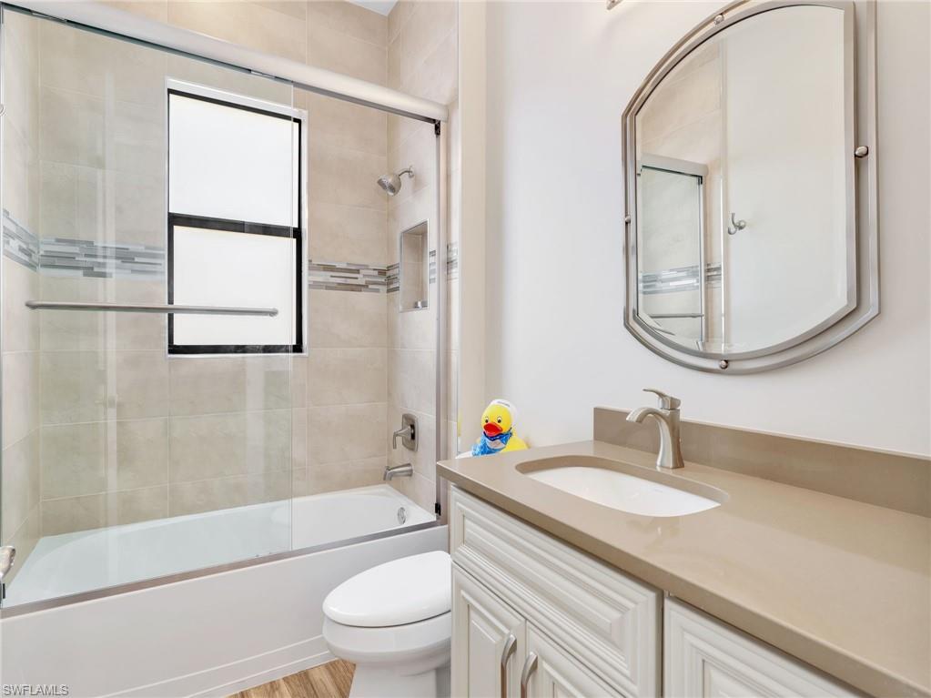3160 27th Avenue Southwest Naples, FL 34117 - Photo 32 of 43 a bathroom with a sink toilet a mirror and shower