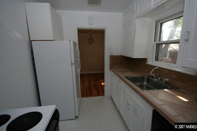 1663 Watt Street Reno, NV 89509 - Photo 4 of 7 a kitchen with a sink and a refrigerator
