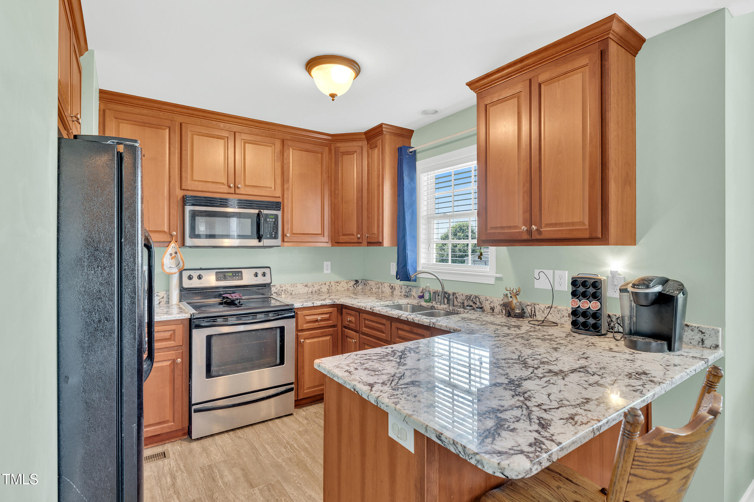 104 JJ Drive Benson, NC 27504 - Photo 10 of 20 a kitchen with stainless steel appliances granite countertop a sink stove and refrigerator
