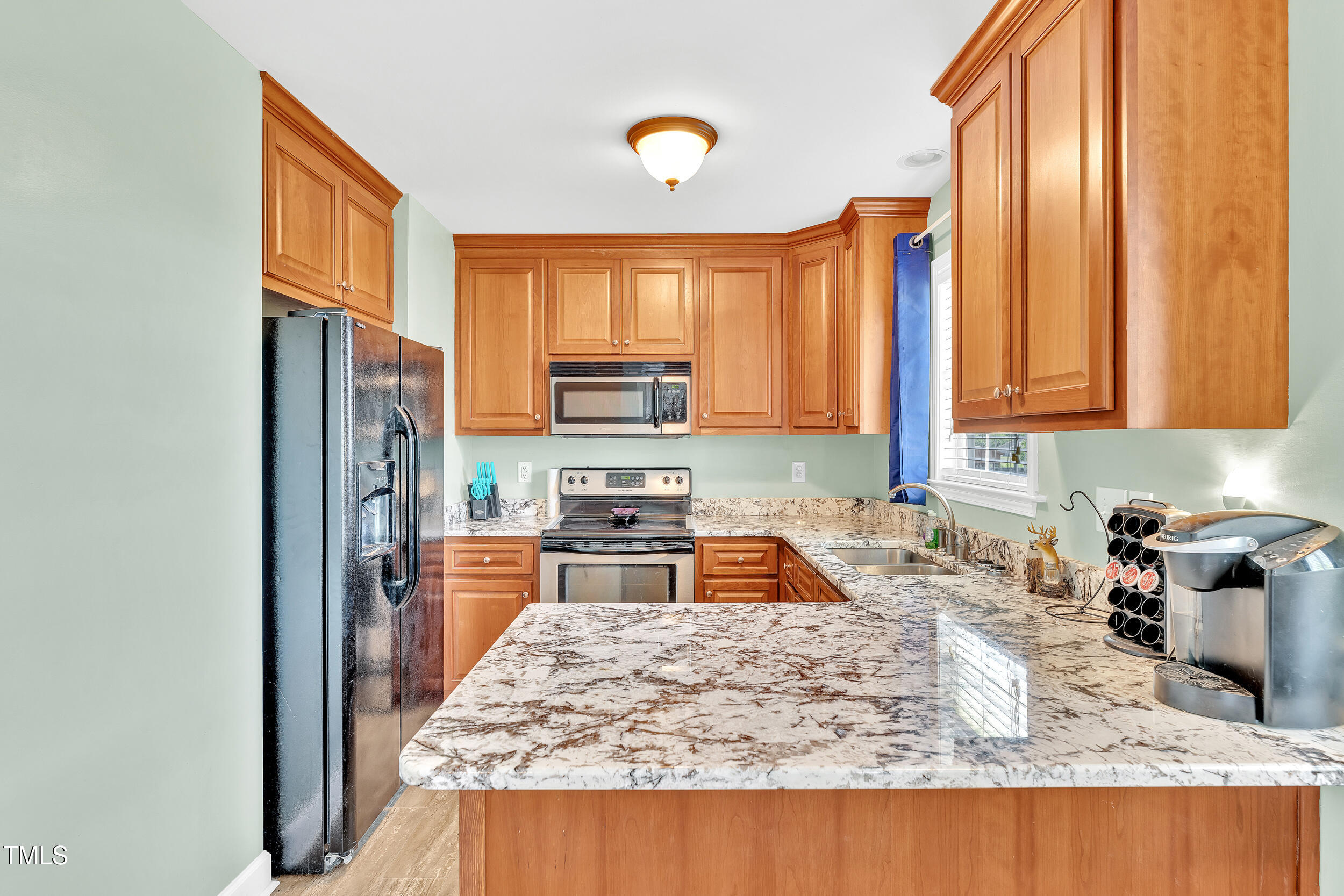 104 JJ Drive Benson, NC 27504 - Photo 11 of 20 a kitchen with stainless steel appliances granite countertop a sink stove and refrigerator