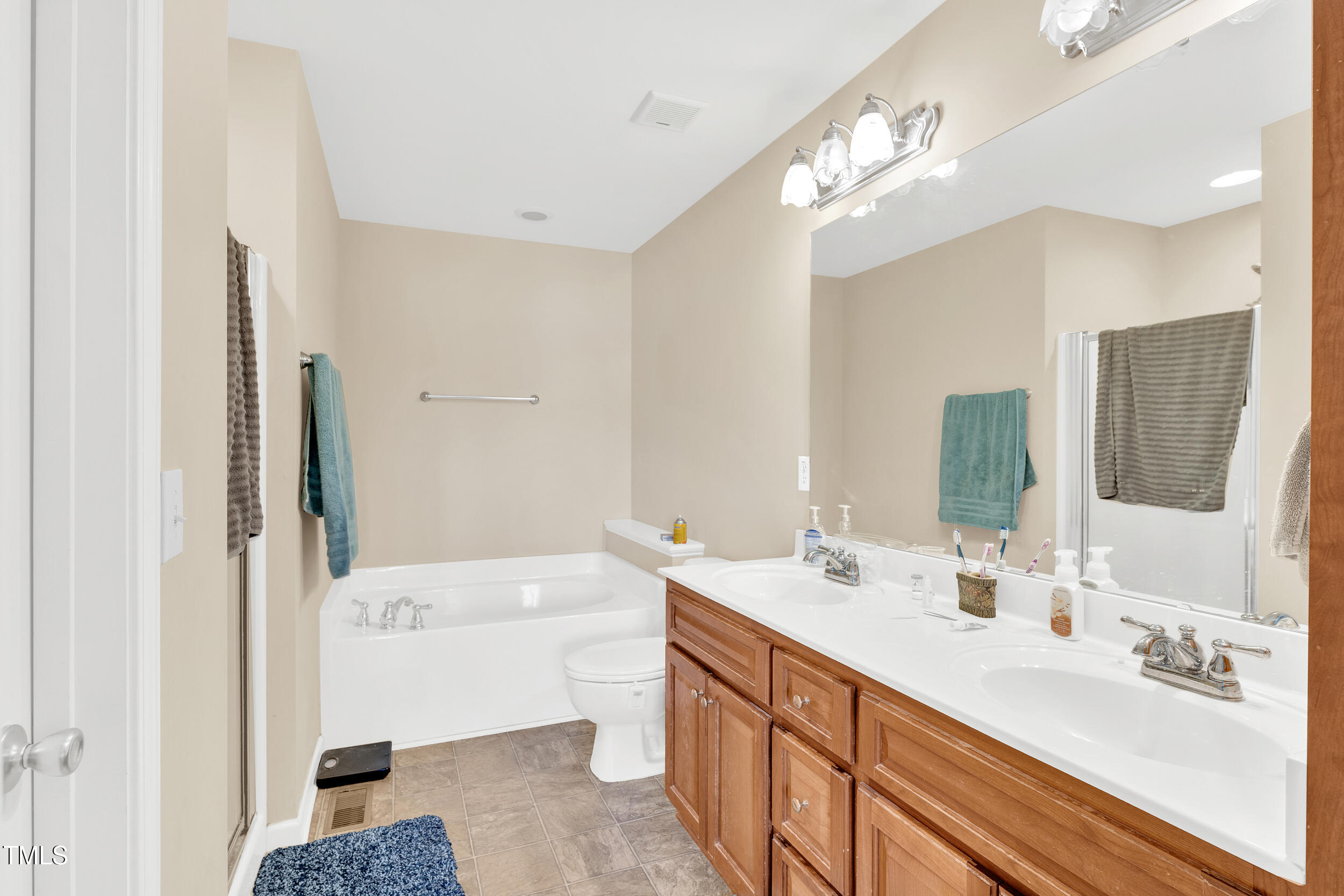 104 JJ Drive Benson, NC 27504 - Photo 9 of 20 a bathroom with a tub sink and mirror
