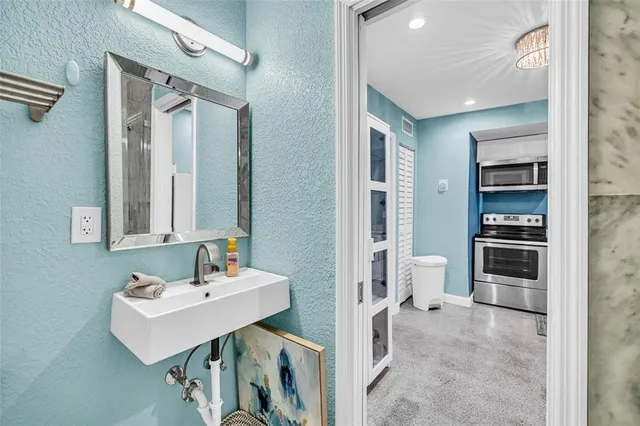 a bathroom with a sink a toilet a shower and a mirror