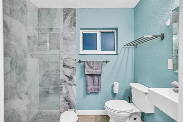 a bathroom with a toilet and a shower