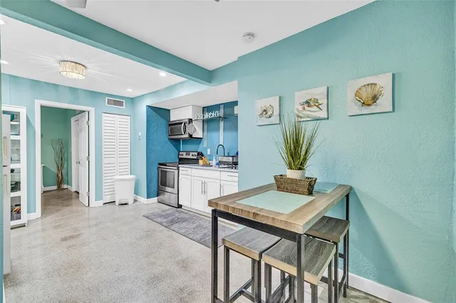 a living room with kitchen island furniture and a kitchen view