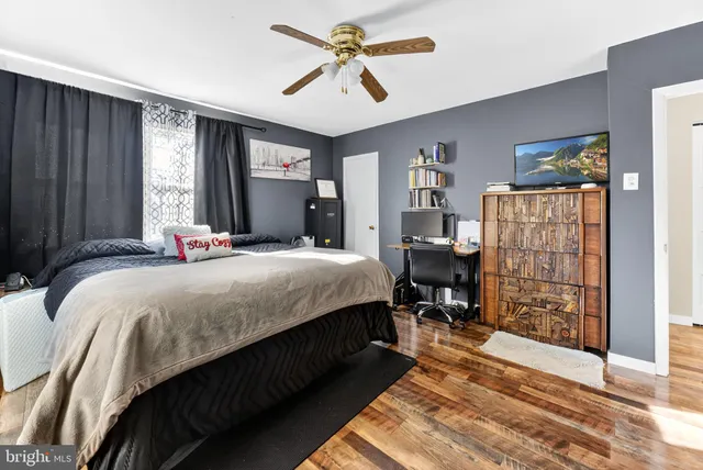 a bedroom with a bed dresser and a window