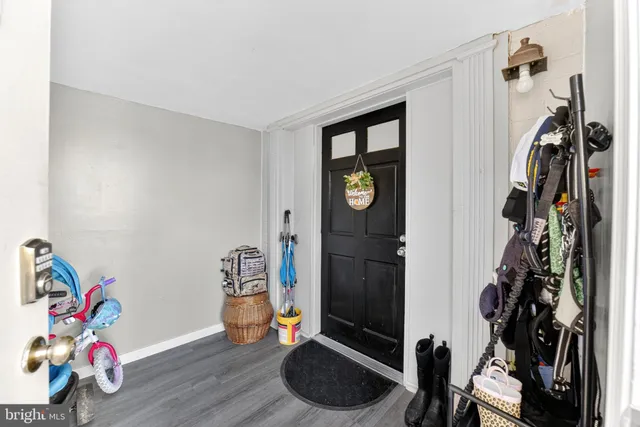 a room with gym equipment and wooden floor