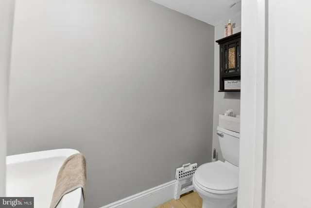 a white toilet sitting next to a bathroom sink
