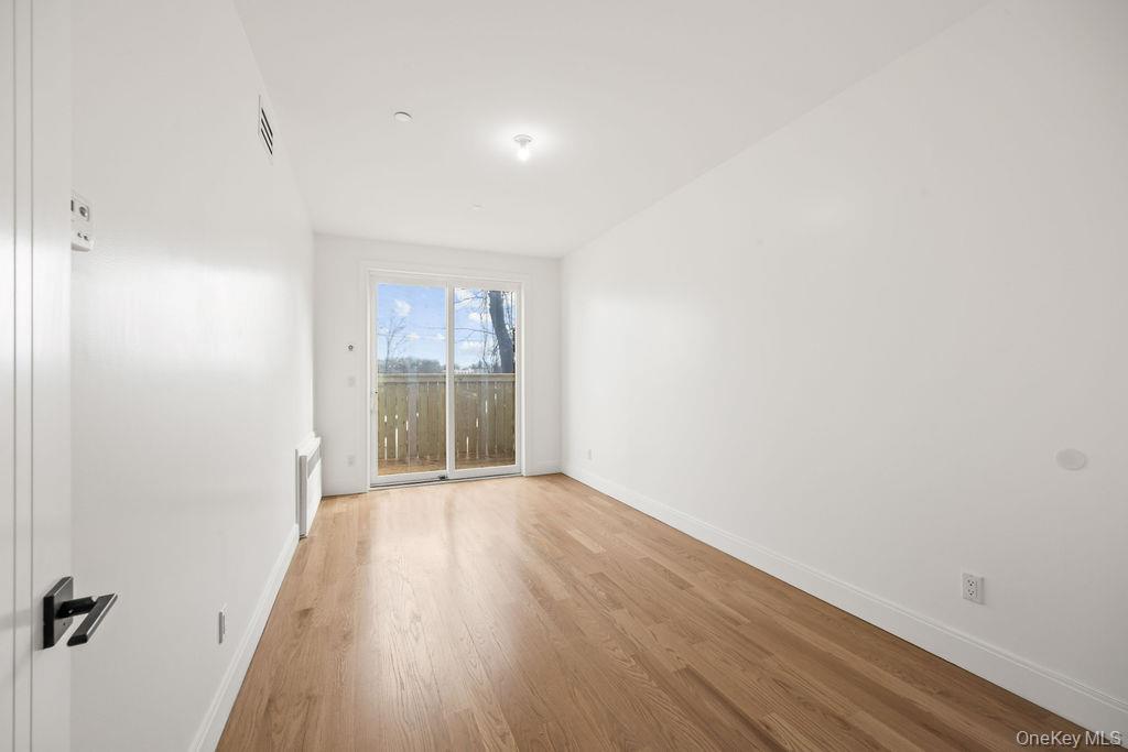 62 Blauvelt Road, Unit 202 Monsey, NY 10952 - Photo 11 of 34 a view of an empty room with wooden floor and a window