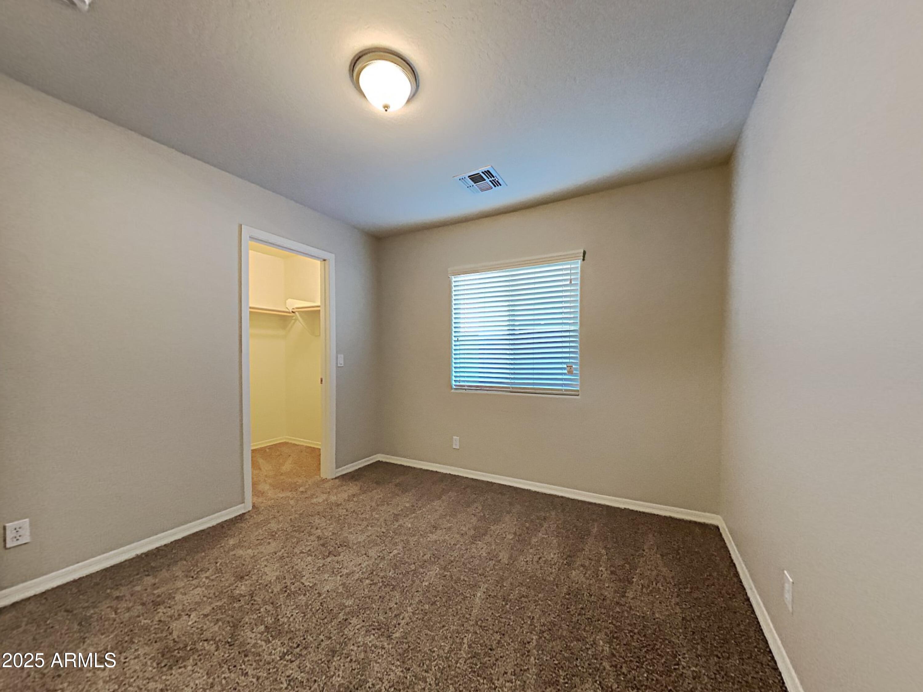 2731 West Grenadine Road Phoenix, AZ 85041 - Photo 11 of 22 an empty room with a window