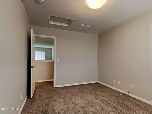 an empty room with a empty space and windows