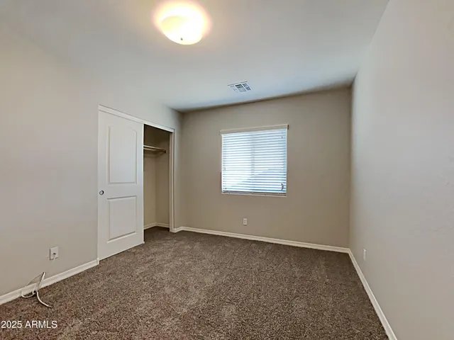 an empty room with a empty space and windows