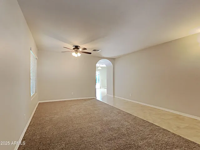 a view of a room with a ceiling fan
