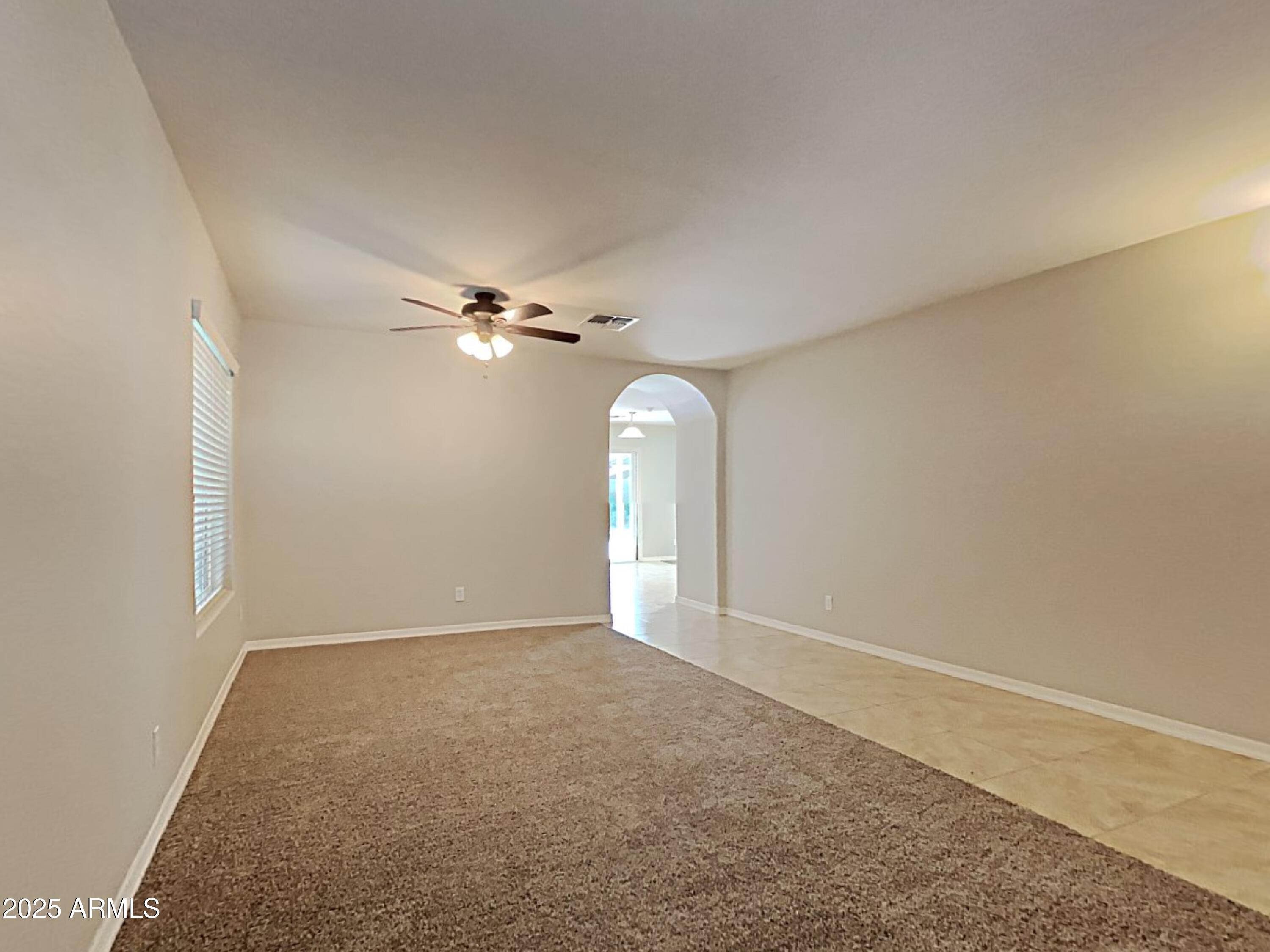 2731 West Grenadine Road Phoenix, AZ 85041 - Photo 4 of 22 a view of a room with a ceiling fan