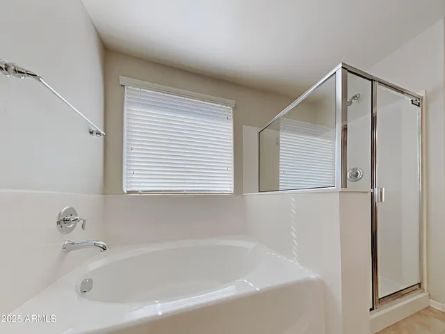 a white bath tub sitting next to a window
