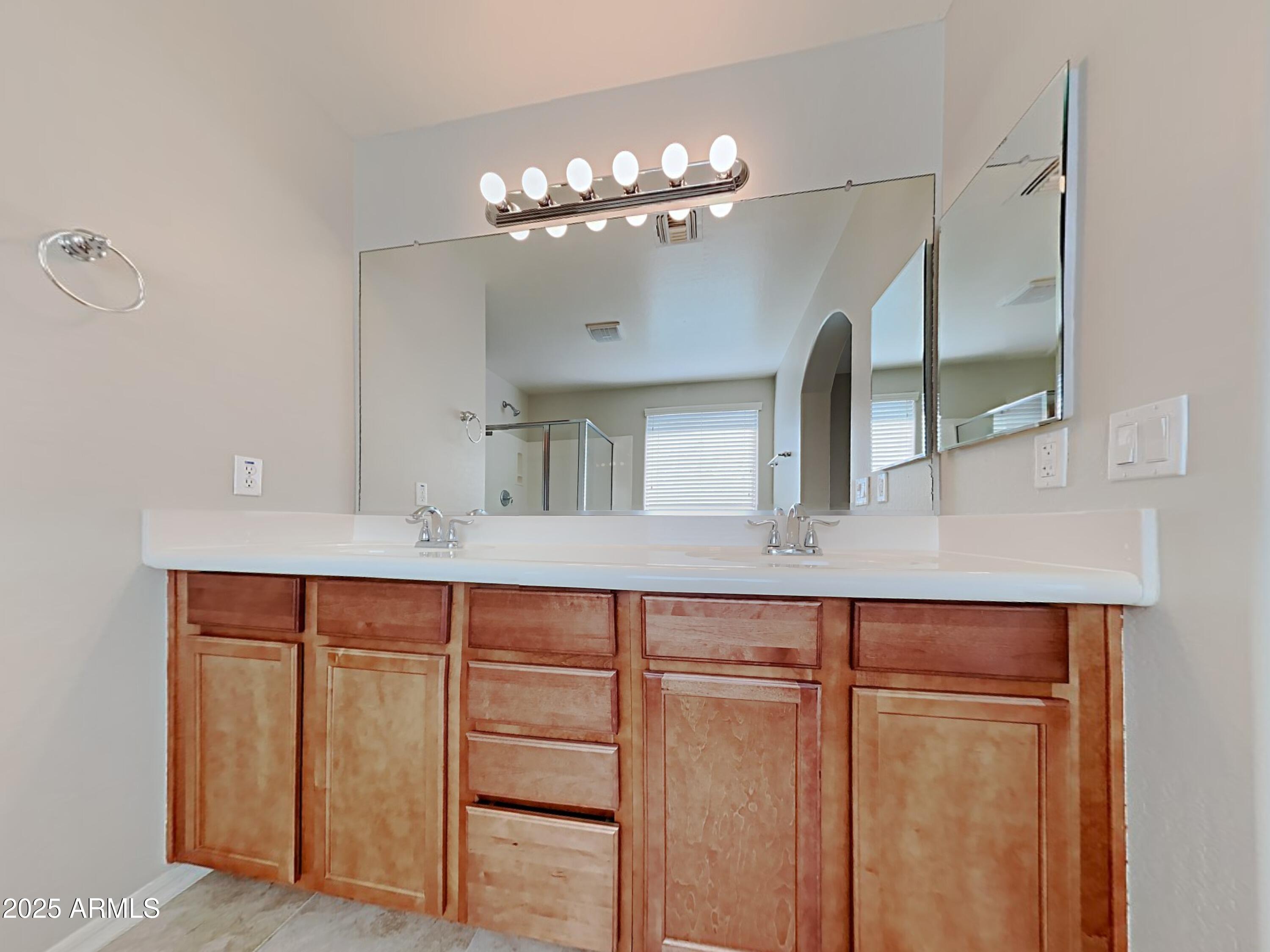 2731 West Grenadine Road Phoenix, AZ 85041 - Photo 10 of 22 a room with cabinets and chandelier