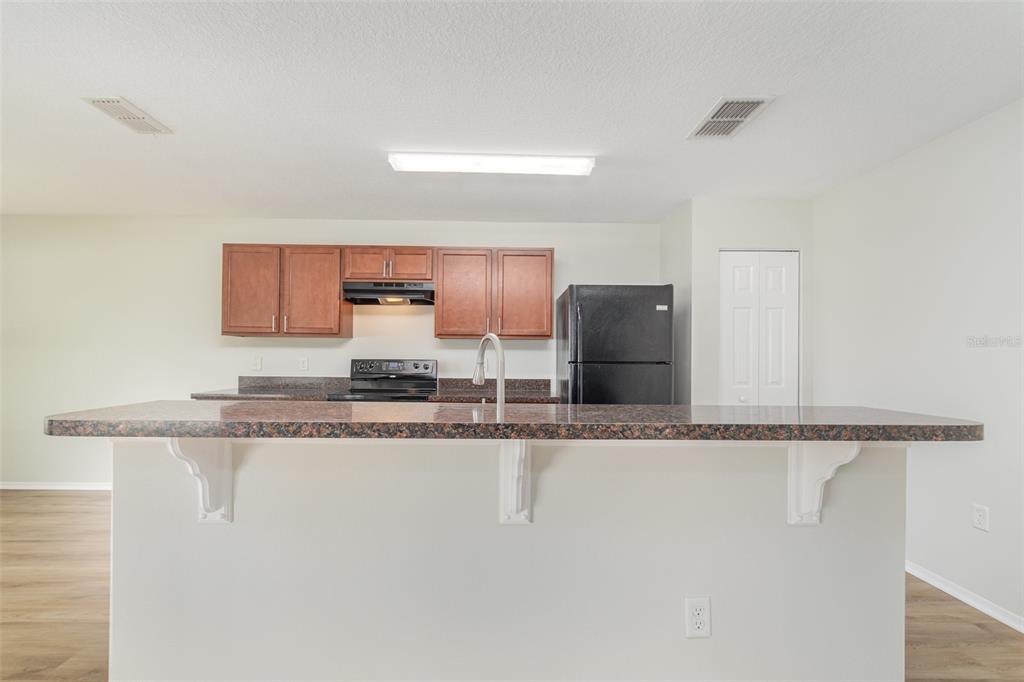 5100 Ballark Street Mount Dora, FL 32757 - Photo 12 of 28 a kitchen with stainless steel appliances granite countertop a sink and a granite counter tops