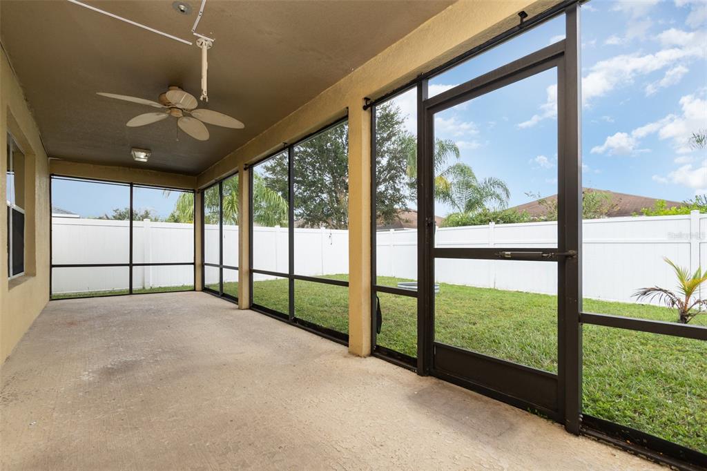 5100 Ballark Street Mount Dora, FL 32757 - Photo 25 of 28 a view of an empty room with chandelier fan and windows