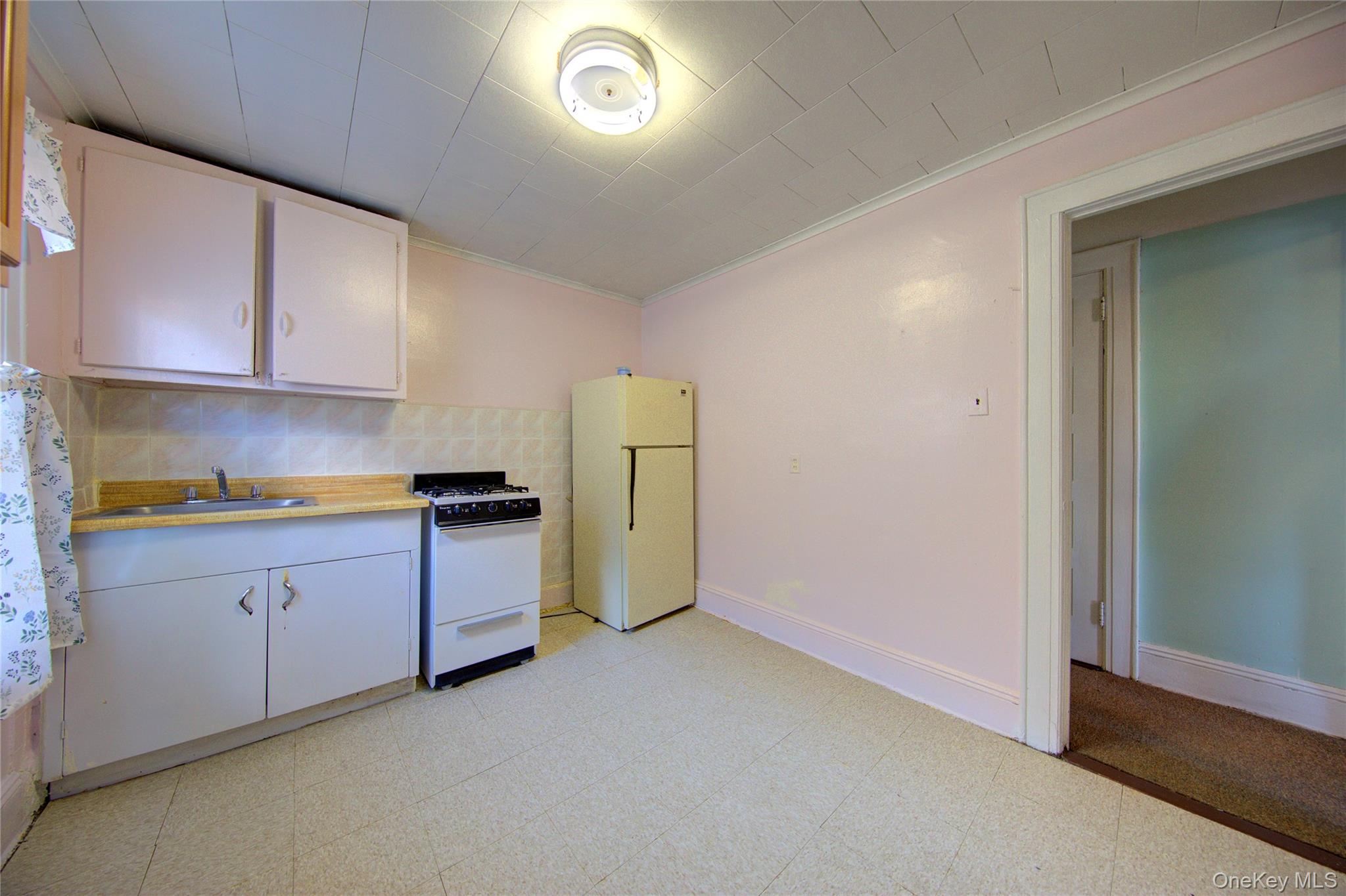 89-10 121st Street Queens, NY 11418 - Photo 14 of 25 a kitchen with stainless steel appliances granite countertop a refrigerator a stove and a sink